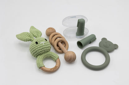 Green teething essentials set with bunny teether, ring grip, and clip pieces