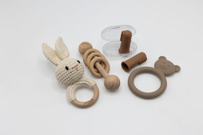 Neutral teething essentials set with bunny teether, ring grip, and teether accessory