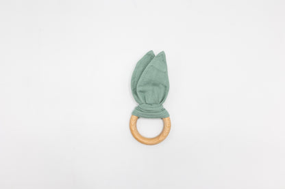 Sage green bunny ear teether with fabric ears and round wooden teething ring