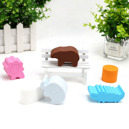 Green shape-sorting cube with brown bear slot and colorful animal blocks