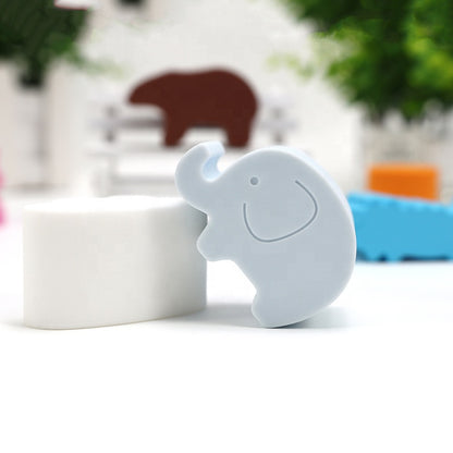 White animal shape block with elephant cutout, beside brown bear block