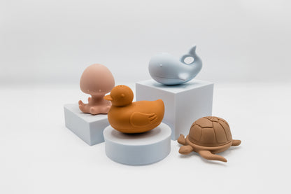 Sea animal bath toy set: orange duck, blue whale, brown turtle, pink octopus.