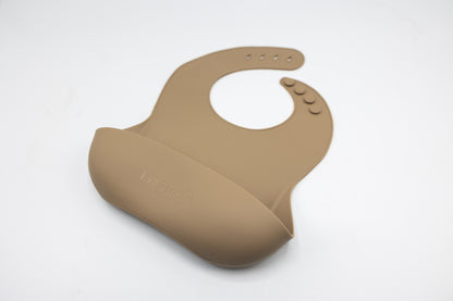 Latte brown silicone bucket bib with round neck opening and snap details