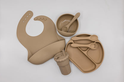 Latte silicone feeding set flat lay, with bib, divided tray, snack pod, and utensils