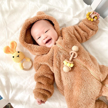 Brown plush crochet bunny baby rattle with wooden ring teether and dangling beads.