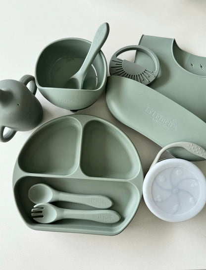 Sage green baby dinnerware set with divided tray, bowl, spoon, fork, and cup