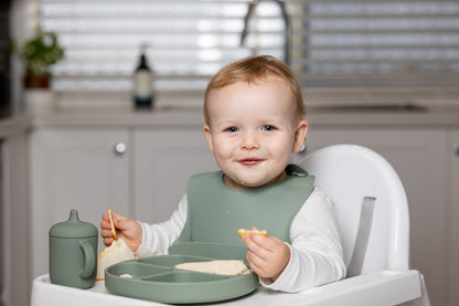Sage baby feeding set on a high chair, with a divided plate and spoon