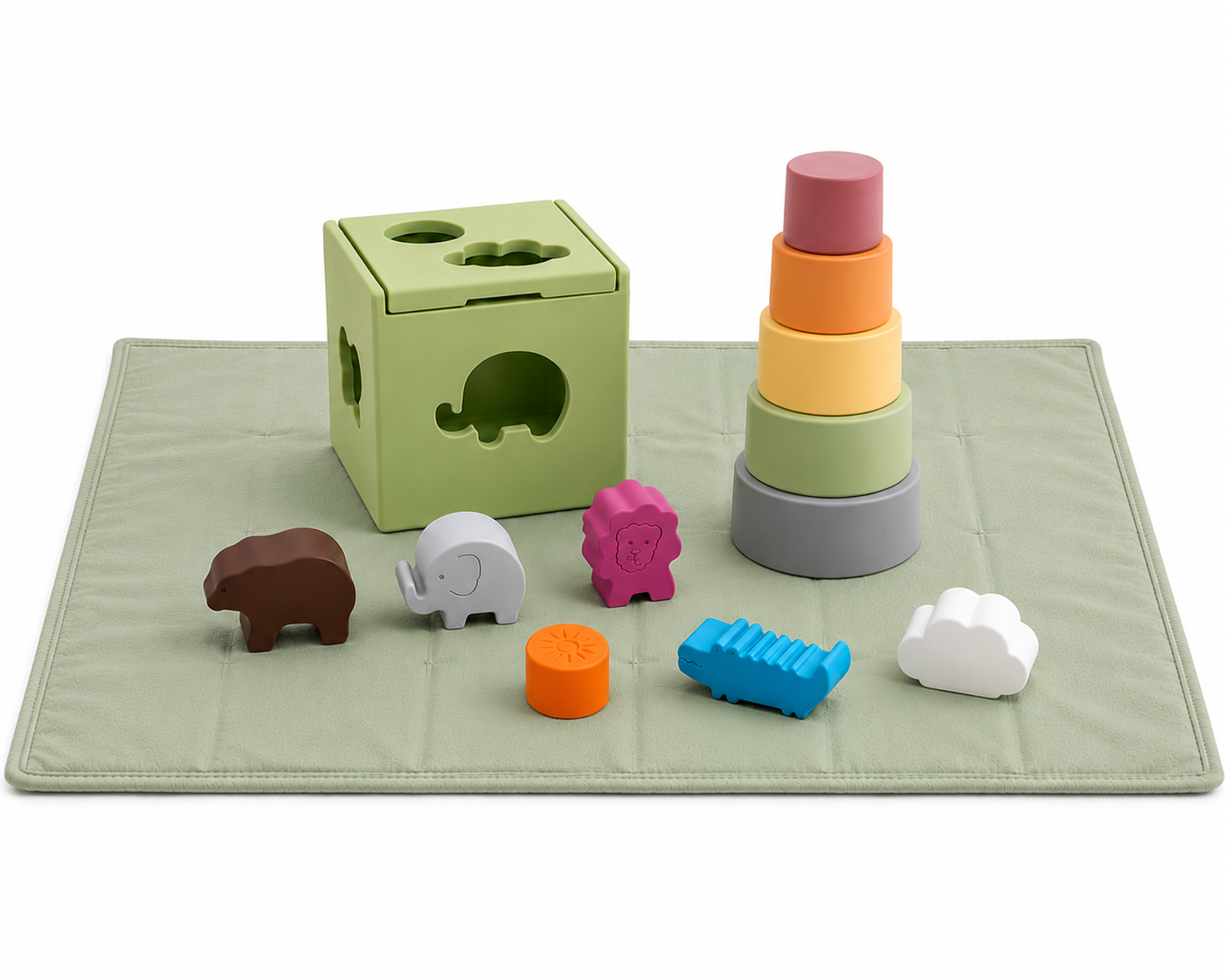 Colorful children's toys including a shape sorter, stacker, and animal shapes on a sage play mat.