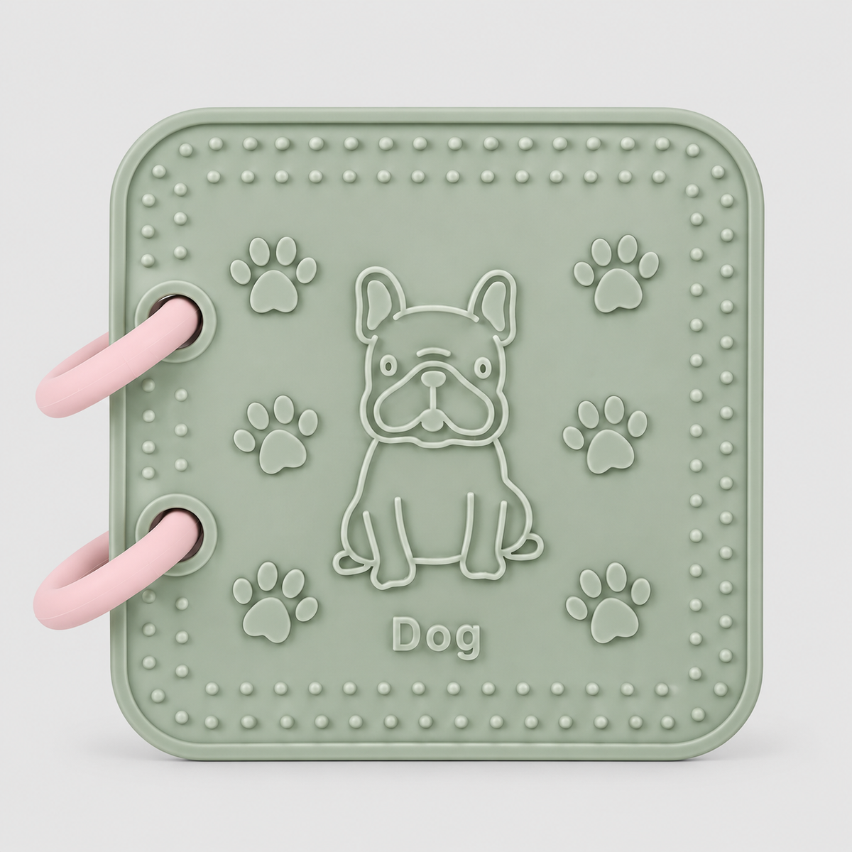 A silicone bath book in sage green featuring front page dog toy. Features an embossed French Bulldog, paw prints, and the word 'Dog' in the center, all in a matching sage green color.
