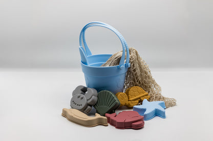 Sand moulding beach set with light blue bucket, sea molds, and beige mesh sand bag