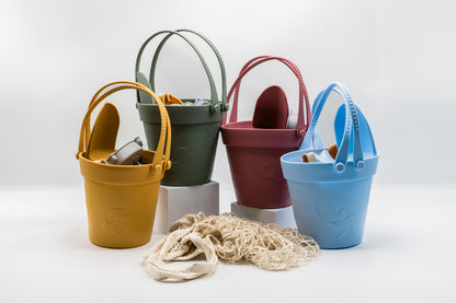 Sand moulding beach set with multiple colorful buckets, sea molds, and beige mesh sand bag