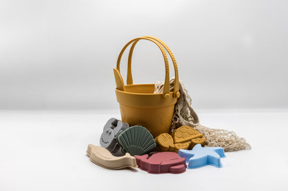 Sand moulding beach set with yellow bucket, sea molds, and beige mesh sand bag