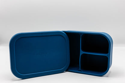 Blue bento box with two compartments and an open lid for quick access