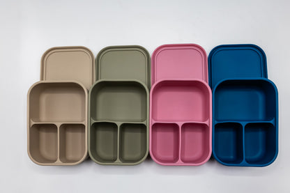 Set of bento boxes in beige, olive, pink and blue, shown open for compartments