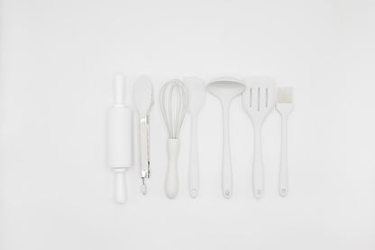 White kitchen utensil set with whisk, spatula, ladle, and brush tools