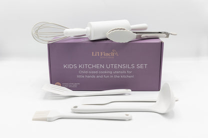 Kids kitchen utensil set with white whisk and spatulas over purple box