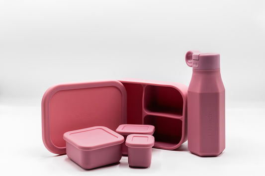 Powder rose lunch box set with open base, stacked containers, and matching drink bottle