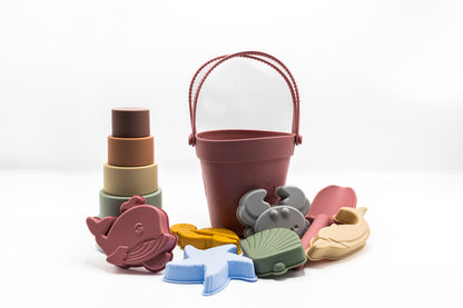 Colorful toy bucket with animal molds and stacked silicone cups, burgundy