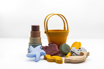 Colorful toy bucket with animal molds and stacked silicone cups, yellow