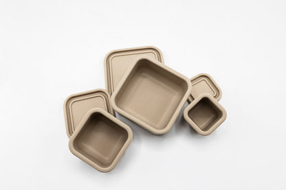 Latte beige silicone snack box set with three square trays and a small cup
