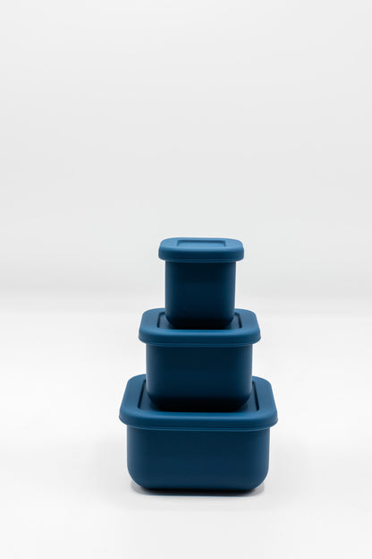 Stacked silicone snack boxes with lids, navy blue color
