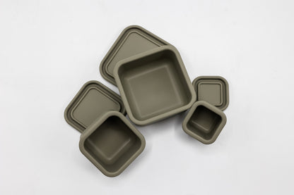 Olive green silicone snack box set with three square trays and a small cup