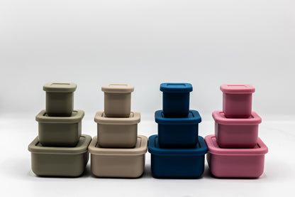Silicone snack boxes in olive, latte, navy, and rose with stackable lids