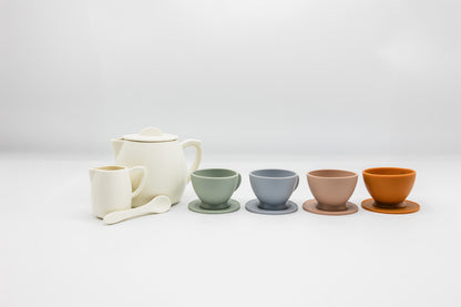 Tea party set with white teapot, four small cups, and two side bowls