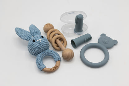 Light blue teething essentials set with bunny teether, ring grip, and clip pieces