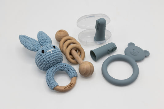 Light blue teething essentials set with bunny teether, ring grip, and clip pieces